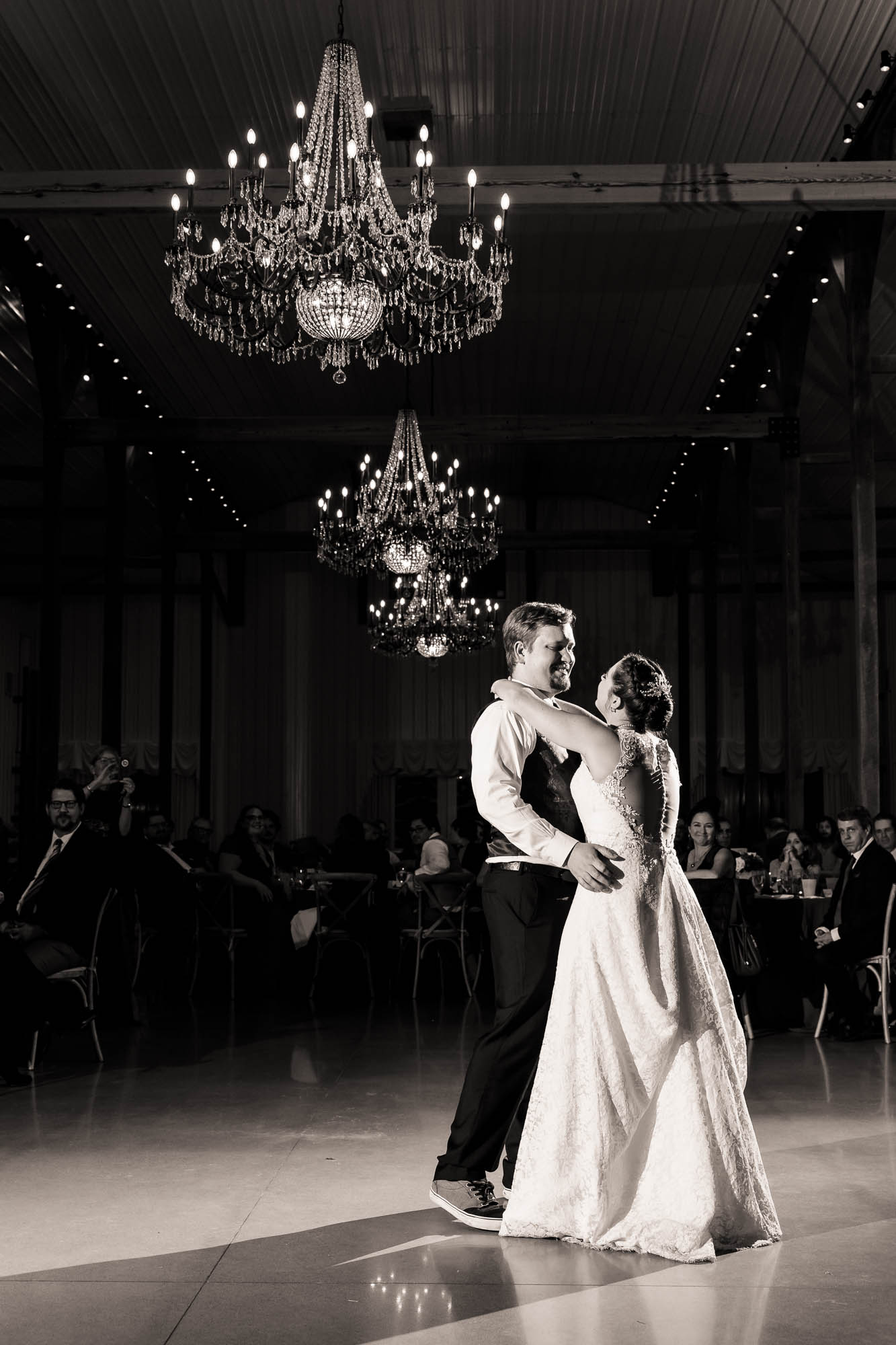 Black and white first dance under crystal chandeliers