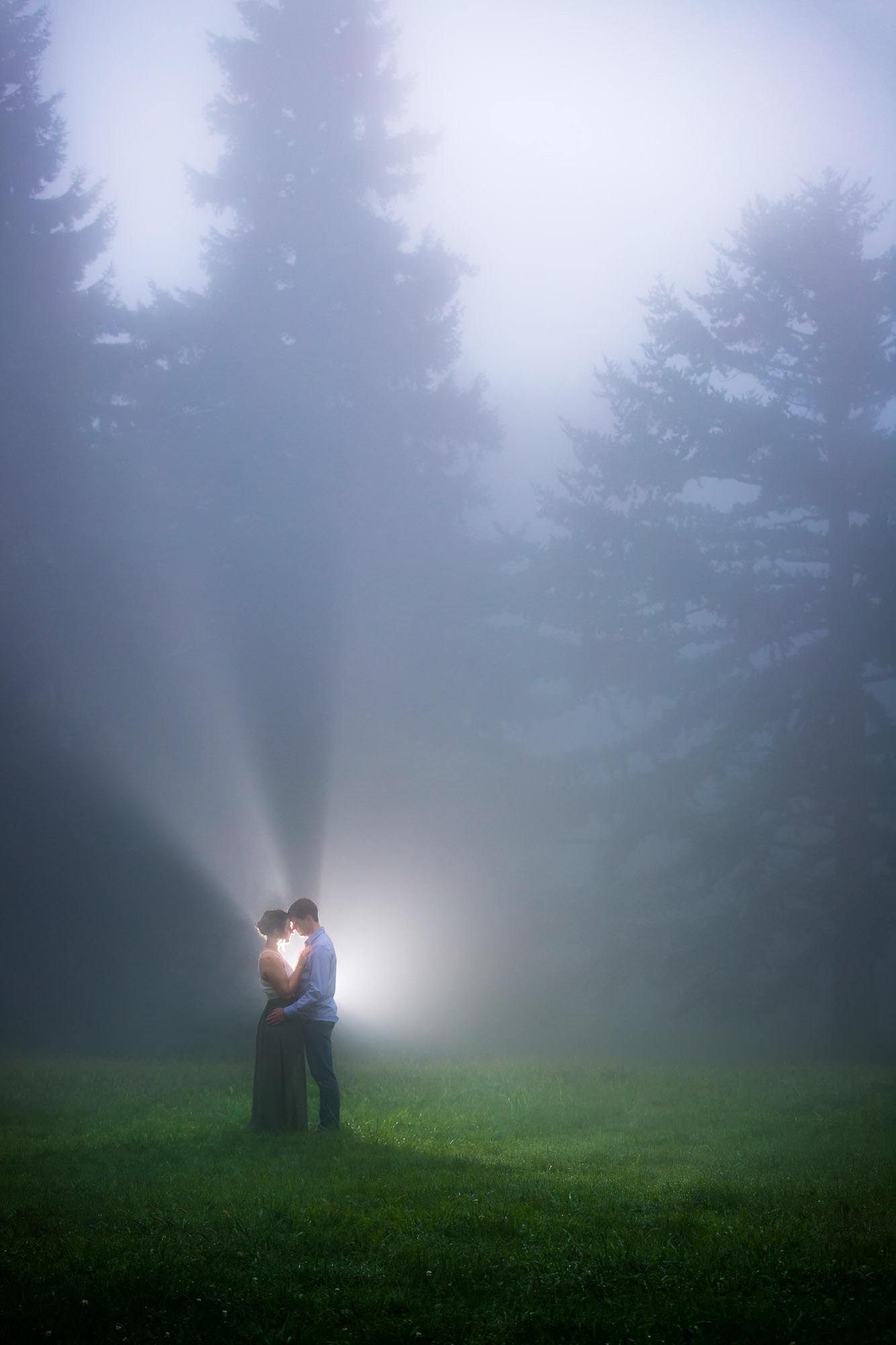 Couple with dramatic fog and light rays