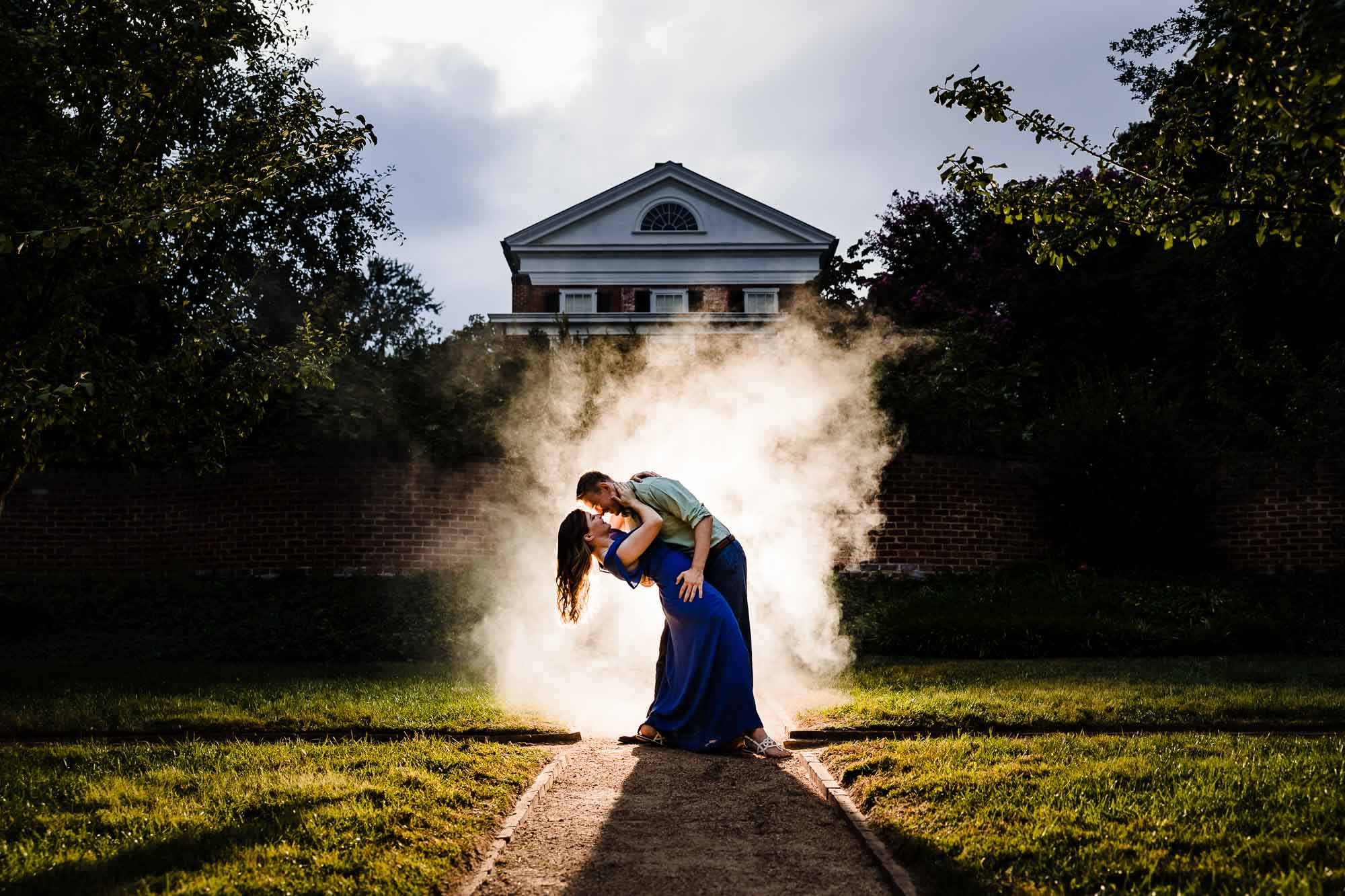 Couple dipping kiss surrounded by smoke at historic Virginia estate